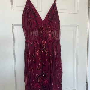 Pretty little thing dark red dress with sequins and open stomach area.